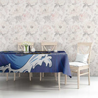 Blue tablecloth with white flying fish and wave motifs, spread across dining table