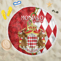 Round red and white Monaco crest beach blanket with decorative fringe edge