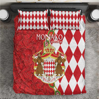 Red and white bedding set with diamond pattern pillows and coat-of-arms duvet