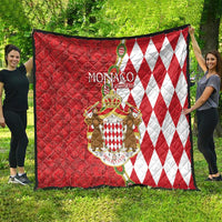 Monaco crest quilt blanket in red and white, featuring diamond pattern side and coat of arms.