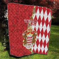 Red and white Monaco coat of arms quilt blanket with diamond pattern and crest center.