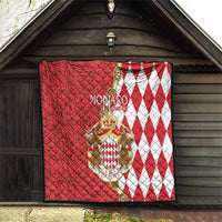 Red and white Monaco crest quilt blanket displayed on wall, with diamond pattern border.