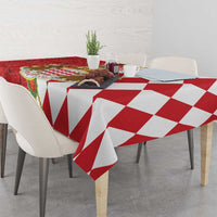 Red and white tablecloth with geometric diamond pattern, draped on table