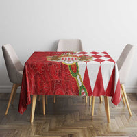 Round red and white tablecloth with crest center and diamond pattern