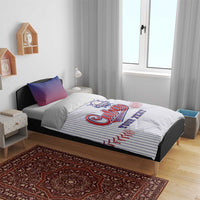 Baseball bedding set on bed: white pinstripe comforter with “Cuba Baseball” logo, blue pillows
