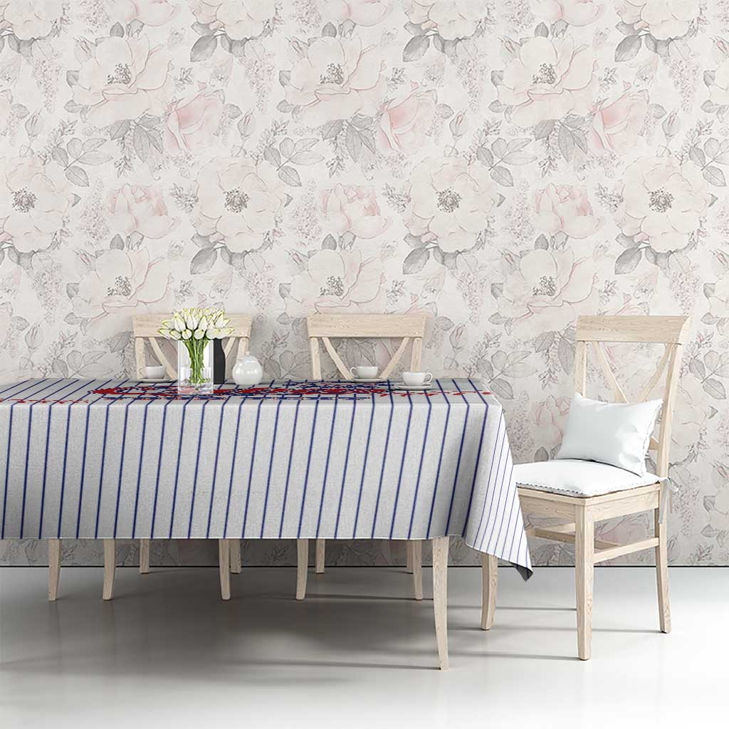 White baseball tablecloth with blue pinstripes and red stitched baseball design on table