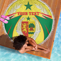 Round beach blanket with white fringe, green and yellow coat of arms crest, “Your Text”