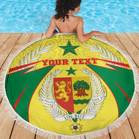 Round beach blanket with white fringe, green and yellow coat of arms crest, “Your Text”