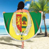 Round beach blanket with white fringe, green and yellow coat of arms crest, large center shield