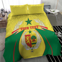 Senegal bedding set close-up: yellow and green duvet with central crest, laurels, and 2 pillows