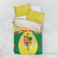 Senegal bedding set flat lay: yellow and green duvet with coat-of-arms crest and 2 pillow covers