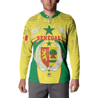 Yellow henley sweatshirt on model, green collar, Senegal crest graphic on chest