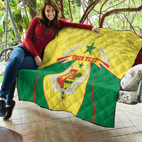 Yellow and green Senegal quilt blanket draped on outdoor seating with coat of arms text