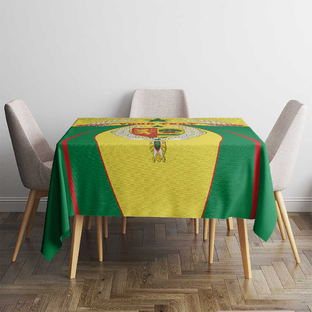 Green and yellow Senegal tablecloth with red trim and coat of arms emblem in center