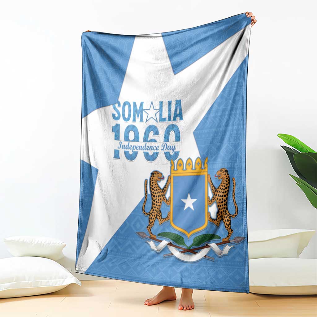Somalia Independence Day blanket coat draped on floor, blue-and-white stripes with emblem
