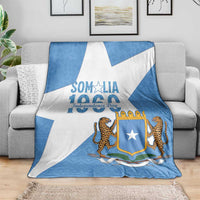 Somalia Independence Day blanket coat, blue and white diagonal pattern on sofa
