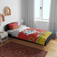 Christmas bedding set on bed in bedroom: red duvet cover with knight on horse emblem
