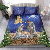 Blue Christmas bedding set with angel and nativity artwork, straw manger and greenery detail