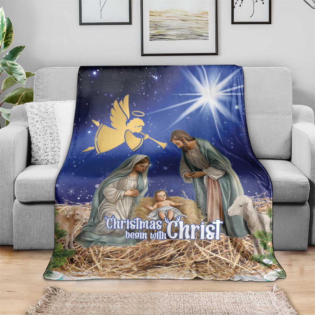 Blue nativity Christmas blanket draped on sofa, “Christmas begin with Christ”