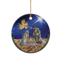 Blue ceramic round Christmas ornament with nativity scene and gold hanging loop.