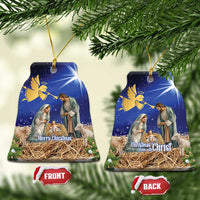 Blue ceramic bell-shaped Christmas ornament with nativity scene, gold hanging loop.