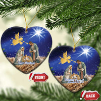 Blue ceramic heart-shaped Christmas ornament with nativity scene, gold hanging loop.