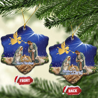 Blue ceramic bell-shaped Christmas ornament with nativity scene, gold hanging loop.