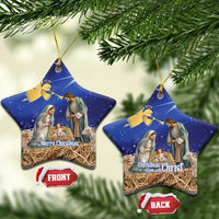 Blue ceramic star-shaped Christmas ornament with nativity scene, gold hanging loop.