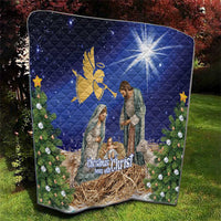 Blue Christmas quilt with nativity scene, golden angel, glowing starburst and quilt stitching