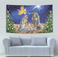 Blue Christmas tapestry with nativity scene, animals by manger, and decorative pine wreaths