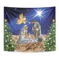Blue Christmas tapestry with nativity manger, angel motif, radiant star, and pine greenery