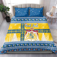 Bedding set featuring blue star pillows and a yellow-and-blue Scandinavian Christmas duvet, God Jul