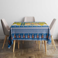 Blue and yellow Scandinavian Christmas tablecloth with repeating figure pattern on square table