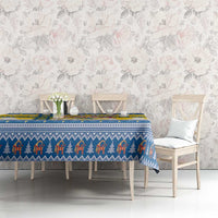 Blue and yellow Scandinavian Christmas tablecloth with patterned trim on dining table
