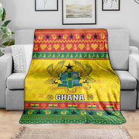 Yellow Ghana Christmas blanket draped over couch, coat of arms crest and 'Ghana' logo