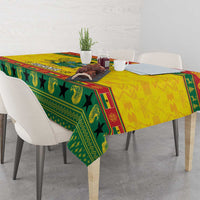 Ghana Christmas tablecloth with green pattern and yellow center, draped over table corners