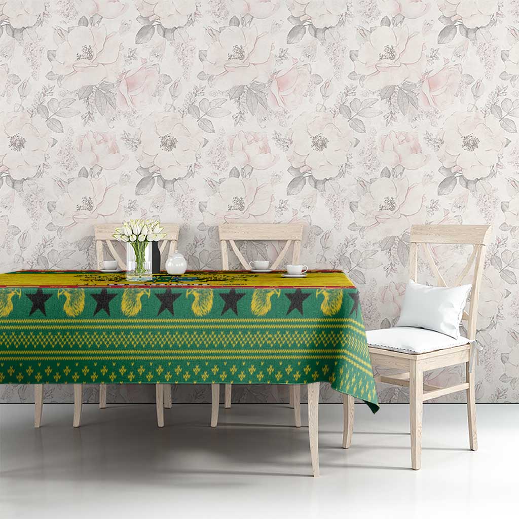 Ghana Christmas tablecloth spread over a table with green, yellow, and red decorative motif border