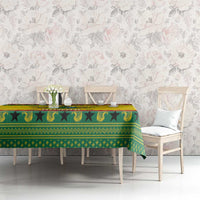 Ghana Christmas tablecloth spread over a table with green, yellow, and red decorative motif border