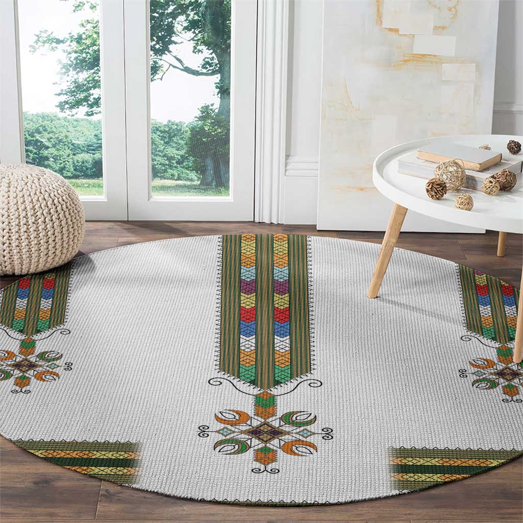 Round white rug with central vertical band and decorative floral cross in multicolor