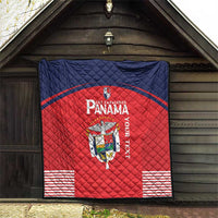 Red Panama quilt blanket hanging outdoors, showing crest logo, navy border, and stripe details.