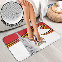 Bath mat with anti-slip grip and Uganda Independence Day emblem in red and white