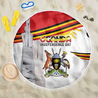 Round beach blanket with Uganda Independence Day crest graphic and white fringe edge