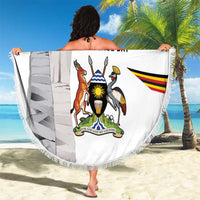 Round beach blanket with Uganda Independence Day graphic and tassel fringe border, held up