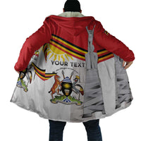 Back hooded cloak coat with red hood, emblem stripe graphic, and gray drape panels