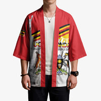 Red kimono coat worn by model; open front with monument and stripe graphic panel