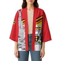 Red kimono coat with open front; monument graphic and stripe detailing on sleeves