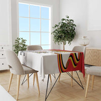 Uganda Independence Day tablecloth on dining table, white with red/yellow/black stripe and emblem