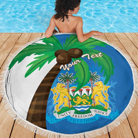 Round Sierra Leone beach blanket featuring coat of arms and flag map, blue-and-green, white fringe