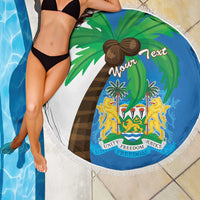 Round Sierra Leone beach blanket with coat of arms, blue-and-green flag map print, fringed edge