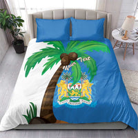 Sierra Leone bedding set featuring blue duvet with palm trees and crest emblem, plus two pillows